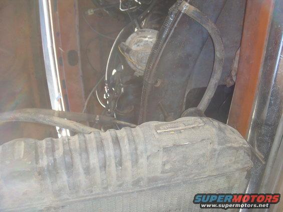 Engine bay with radiator and hoses visible
