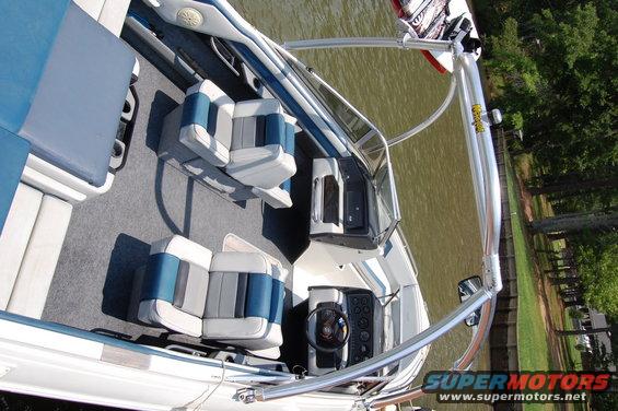 1988 Sea Ray Sundancer 268 interior with blue and gray seats and dashboard