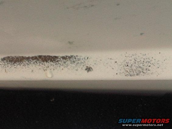 Close-up of a boat hull with discoloration and water marks
