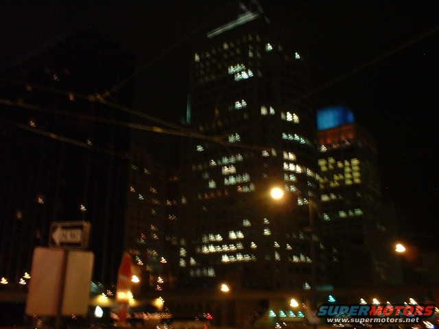 Cityscape at night with illuminated buildings and streetlights