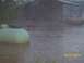 1974 Dodge 1500 - A yellow truck and a large propane tank sit in floodwaters near a barn, with a date stamp of 05/03/2010.