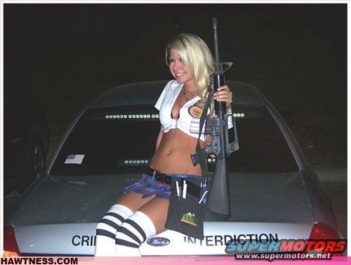 Woman with rifle on car trunk with 'INTERDICTION' text