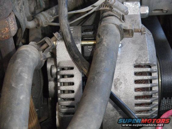Alternator with hoses and wiring in engine bay