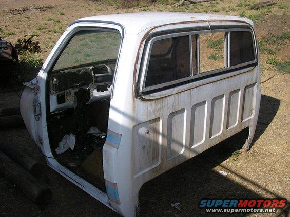 White 1973 Chevrolet C/K Pickup truck cab, showing interior and side panel with rectangular indentations
