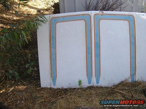 Hood with two rectangular blue and brown trim sections. It's lying on the ground