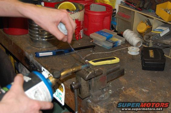 Filling the copper lug with flux core solder.