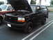 1986 Ford Bronco - Black Ford Bronco parked in a lot with its hood open, next to another vehicle.