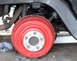 1976 Ford Ranchero - Detail shot of a vehicle's wheel and suspension system, showing painted components.
