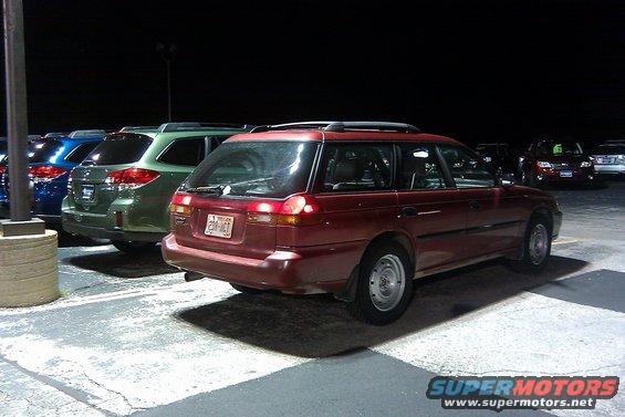 red station wagon parked at night, license plate 230-MCT