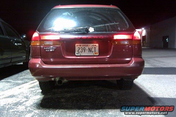 Red 1998 Subaru Legacy wagon rear view, Wisconsin license plate 239-NCT, parked next to another car