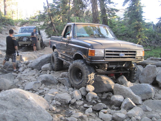 Ford F-Series truck navigating a rocky trail with another off-road vehicle behind it