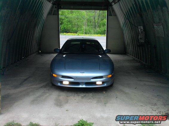 Blue 1994 Ford Probe parked inside a Quonset hut garage
