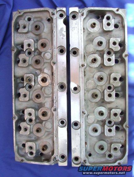 two aluminum engine cylinder heads side by side