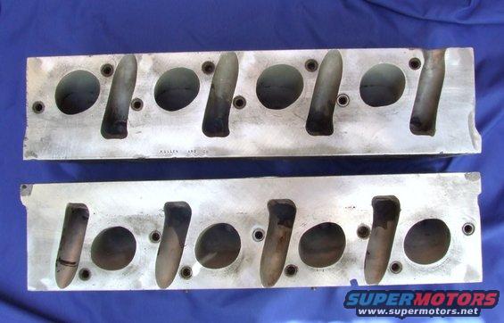 Pair of aluminum engine cylinder heads with visible text 'ALLEN ARD CO'