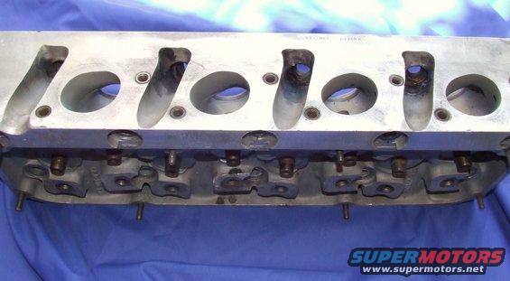 Aluminum engine cylinder head with intake and exhaust ports visible