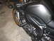 2008 Yamaha FZR1000 - A motorcycle with frame sliders is parked indoors on a concrete floor.