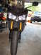2008 Yamaha FZR1000 - Front view of a black motorcycle with gold suspension components and orange turn signals, parked indoors with a Jeep visible in the backgro…