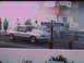 1992 Ford Mustang - A silver coupe drag car sits on the track with smoke in the background and spectators watching.