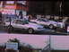 1992 Ford Mustang - Two silver Ford Mustangs prepare for a drag race, one blue flame decals.