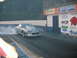 1992 Ford Mustang - A silver third-generation Chevrolet Camaro performs a burnout on a drag strip, with sponsor banners visible in the background.
