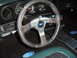 1973 Ford Ranchero - The interior of a 1973 Ford Ranchero features an aftermarket steering wheel and original Ford badging on the floor mats.
