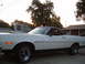1973 Ford Ranchero - A white 1973 Ford Ranchero is seen from the front three-quarter angle, its distinctive coupe utility body style and black accents.