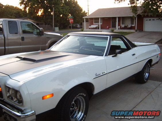 1973 Ford Ranchero parked in driveway next to a pickup truck