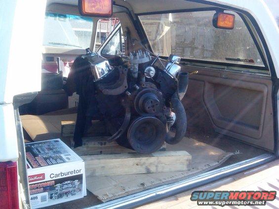 Engine and a box labeled "Edelbrock Carburetor" are in the back of a vehicle