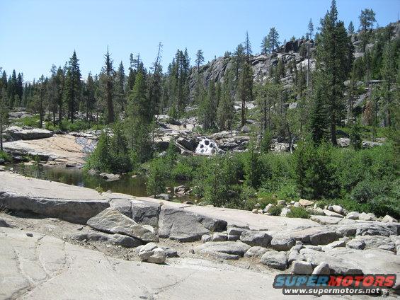 Rocky terrain with trees and a small waterfall