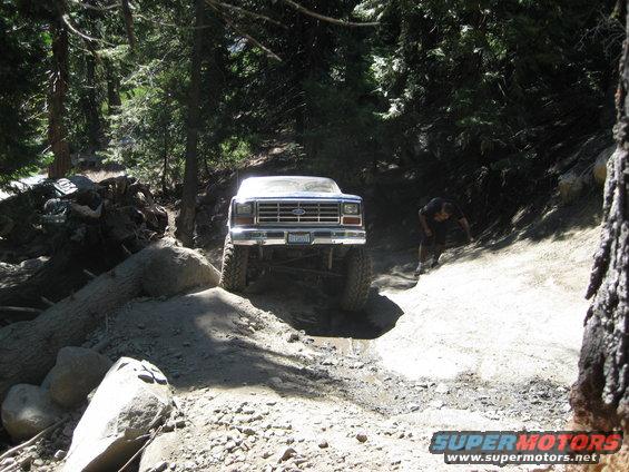 Front view of lifted 1980s Ford Bronco on rocky trail