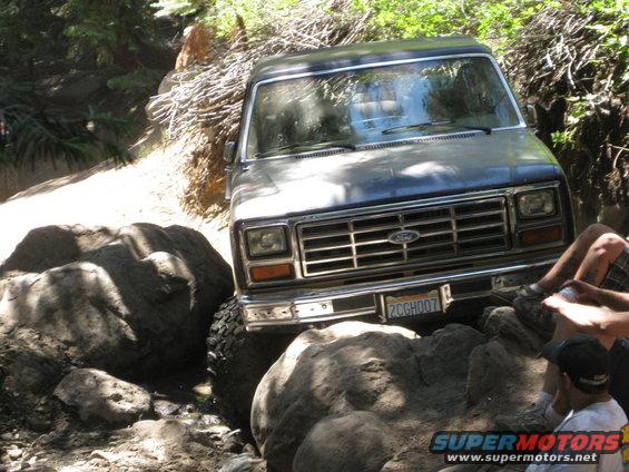 Ford Bronco navigating large rocks on a trail