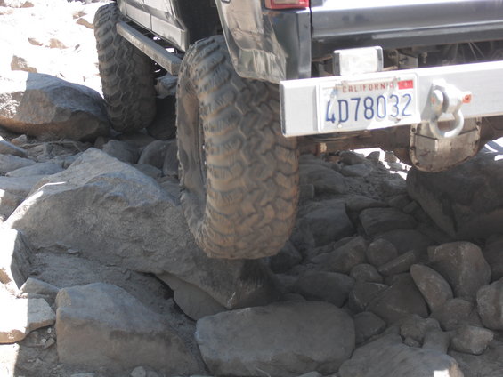 1991 Ford Bronco rear tire on rocks, California license plate 4D78032 visible