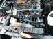 1968 Mercury Cougar - Close-up view of a vehicle's engine compartment, showing the air cleaner, radiator, and fan.