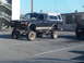 1986 Ford Bronco - This lifted pickup truck, equipped with a camper shell, is parked in a lot. The registry claims it is a 1986 Ford Bronco, but it does not m…