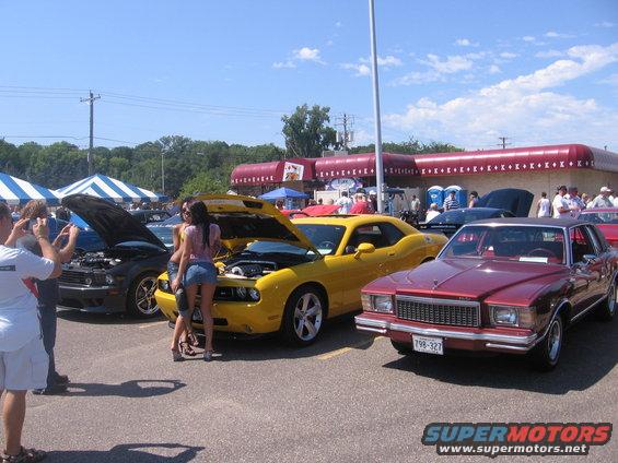 Maroon 1978 Chevrolet Monte Carlo with hood open, parked at an outdoor event