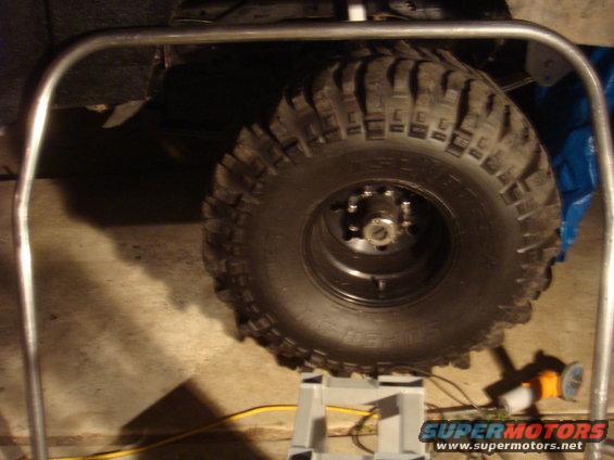 Tire on a jack stand, part of a roll cage visible. The vehicle appears to be a 1992 Ford Bronco