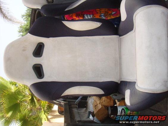 Car seats with dark blue and light gray upholstery, some with harness cutouts
