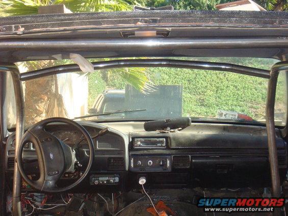 1992 Ford Bronco interior with roll cage, dashboard, and steering wheel visible