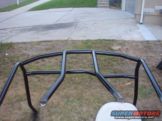 Black roll cage with metal tubing, outdoors