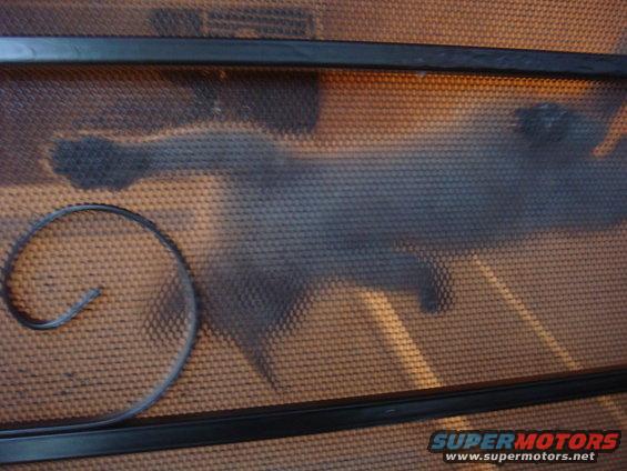 wrought iron scrollwork on a textured background with a "SUPERMOTORS" watermark