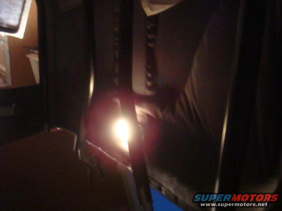 Interior view of a vehicle with a bright light illuminating the dashboard area