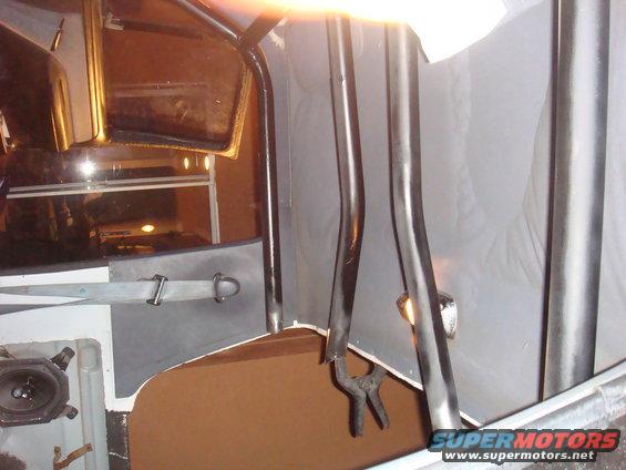 interior view of roll cage tubing and seatbelt