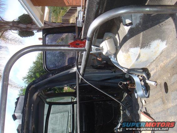Roll cage and seatbelt inside a dark vehicle interior