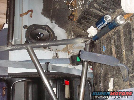 Vehicle interior with roll cage, speaker, seatbelt, and a Bud Light can