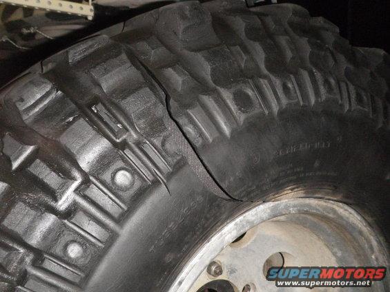 Tire with a large bulge and visible damage to the sidewall