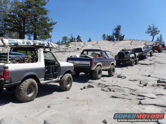 1991 Ford Bronco and other off-road vehicles on a rocky trail