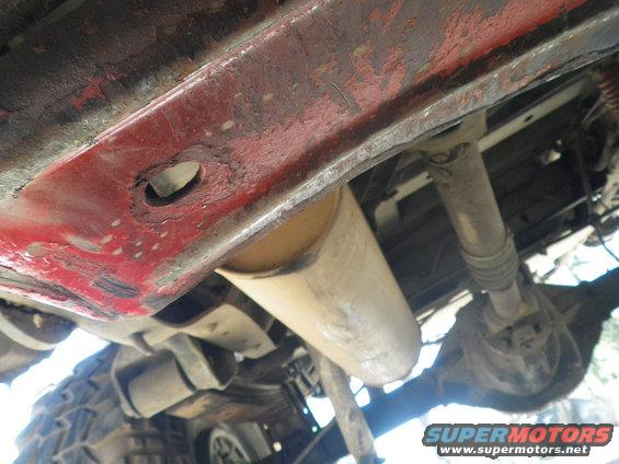 Underside view of vehicle frame, exhaust pipe, driveshaft, and rear axle