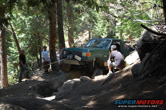 Green 1993 Ford F-150 on a rocky trail, front view with winch