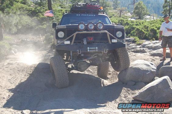 Off-road vehicle with "GO PREPARED" on windshield navigating rocks
