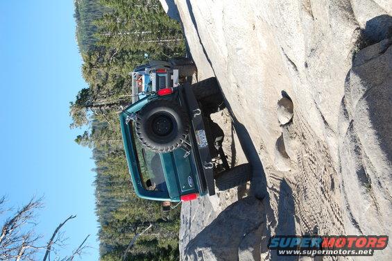 1993 Jeep Wrangler on a rock face, rear view, green